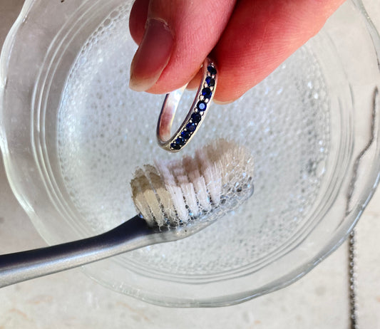 Cleaning jewelry with soapy water and a toothbrush